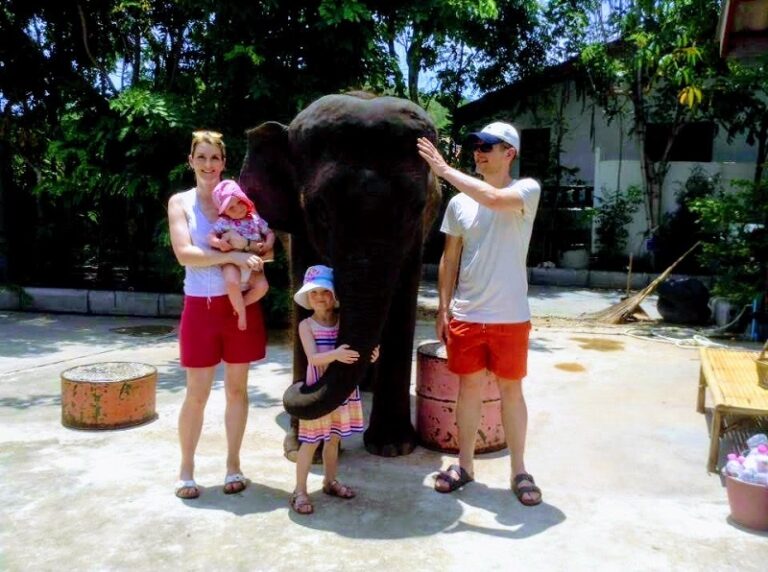 Family standing next to an elephant at Hutsadin Elephant Foundation in Hua Hin, Thailand, highlighting ethical tourism and wildlife conservation.