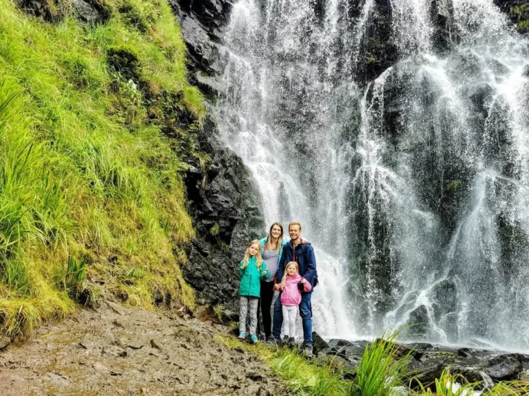 Us with our two girls standing in front of the magnificent Clashnessie Falls waterfall