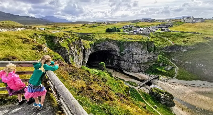 NC500 Campsites cover photo of the kids at Smoo Cave