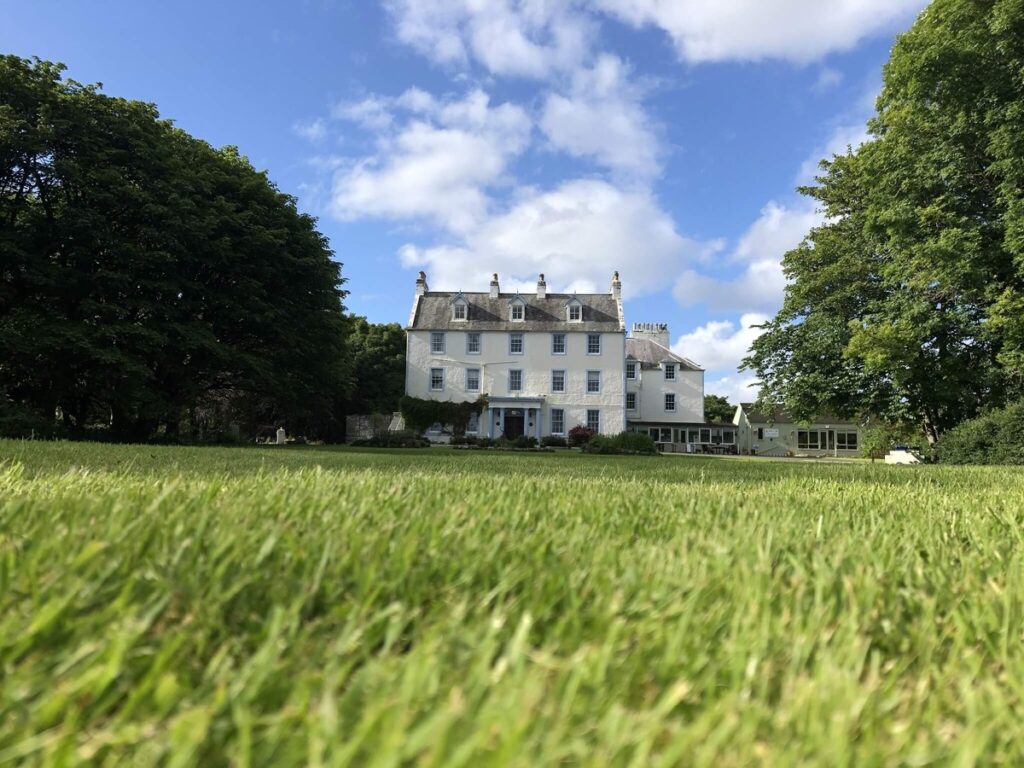 A welcoming view of Force of Nature Guest House along the North Coast 500, offering cozy accommodations surrounded by Scotland’s breathtaking landscapes.