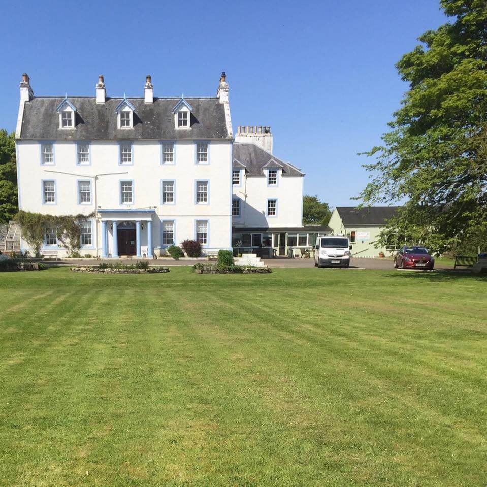 Exterior shot of Force of Nature Guest House, highlighting its scenic surroundings and inviting atmosphere along the North Coast 500 route.