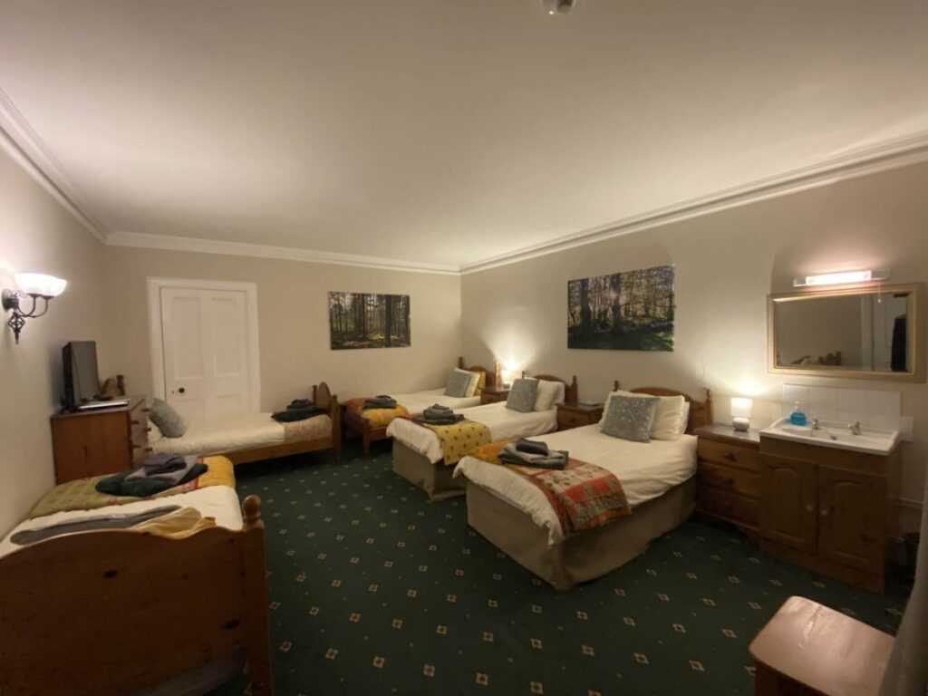 Interior view of Force of Nature Guest House, featuring warm lighting, comfortable furnishings, and a welcoming atmosphere along the North Coast 500 route.