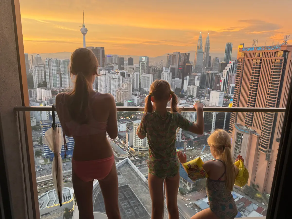 Our kids overlooking Kuala Lumpur skyline at sunset reflecting the experience of Malaysia