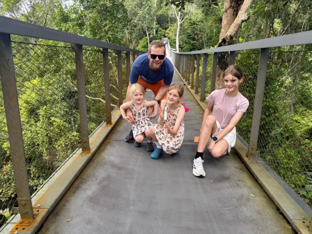 Our family on the canopy walkway at The Habitat Penang Hill, surrounded by rainforest