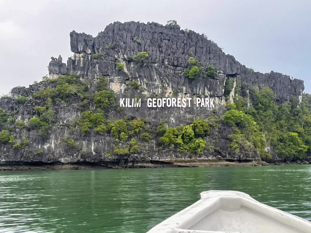 View of Kilim Geoforest Park limestone cliffs from a boat in Langkawi—an eco-adventure highlight on our Malaysia itinerary.
