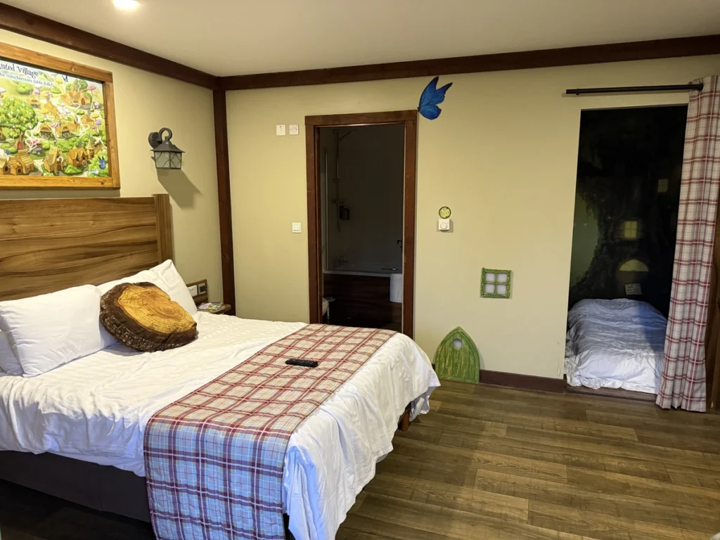 Fairy-tale themed bedroom with glowing tree mural at Alton Towers Enchanted Village during Santa Sleepover