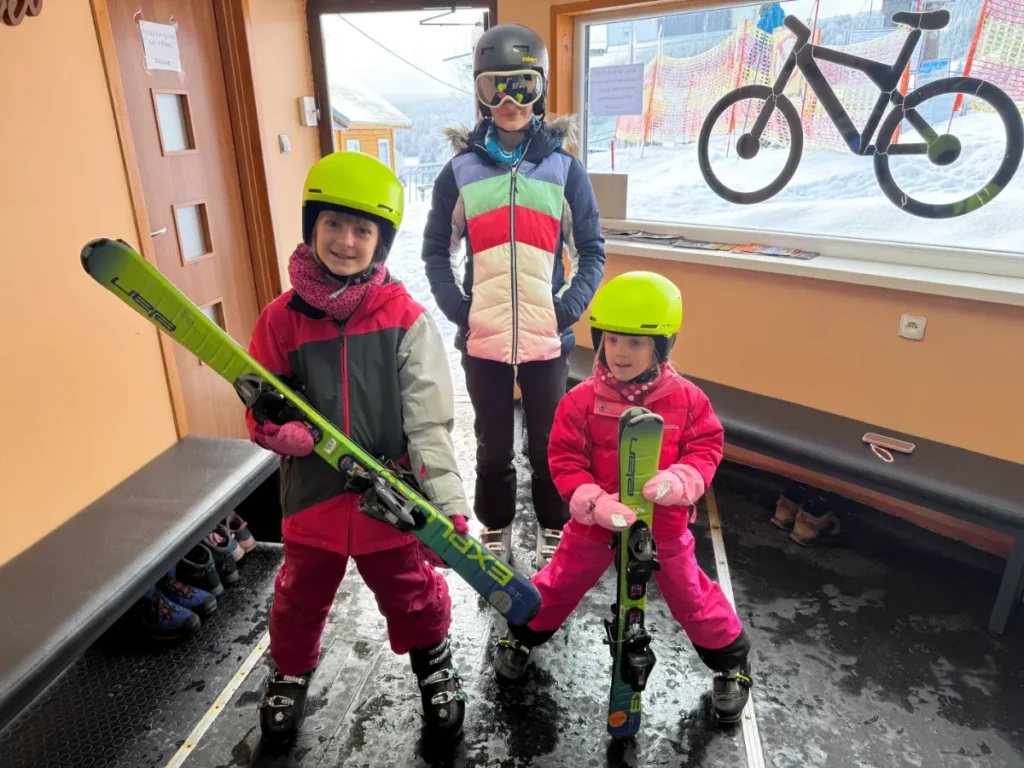 Children getting fitted for ski equipment at a rental shop in Zieleniec beginner ski resort in Poland